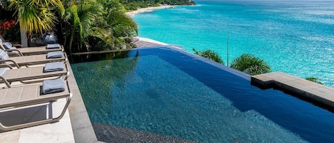 An infinity pool, pool loungers
