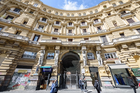 A historic building with ornate architecture, multiple balconies, and a central entrance.