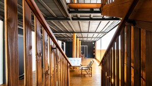 A wooden staircase leading to a dining area with a table and chairs. - Hotel Gigante Beach Itapema (Itapema)