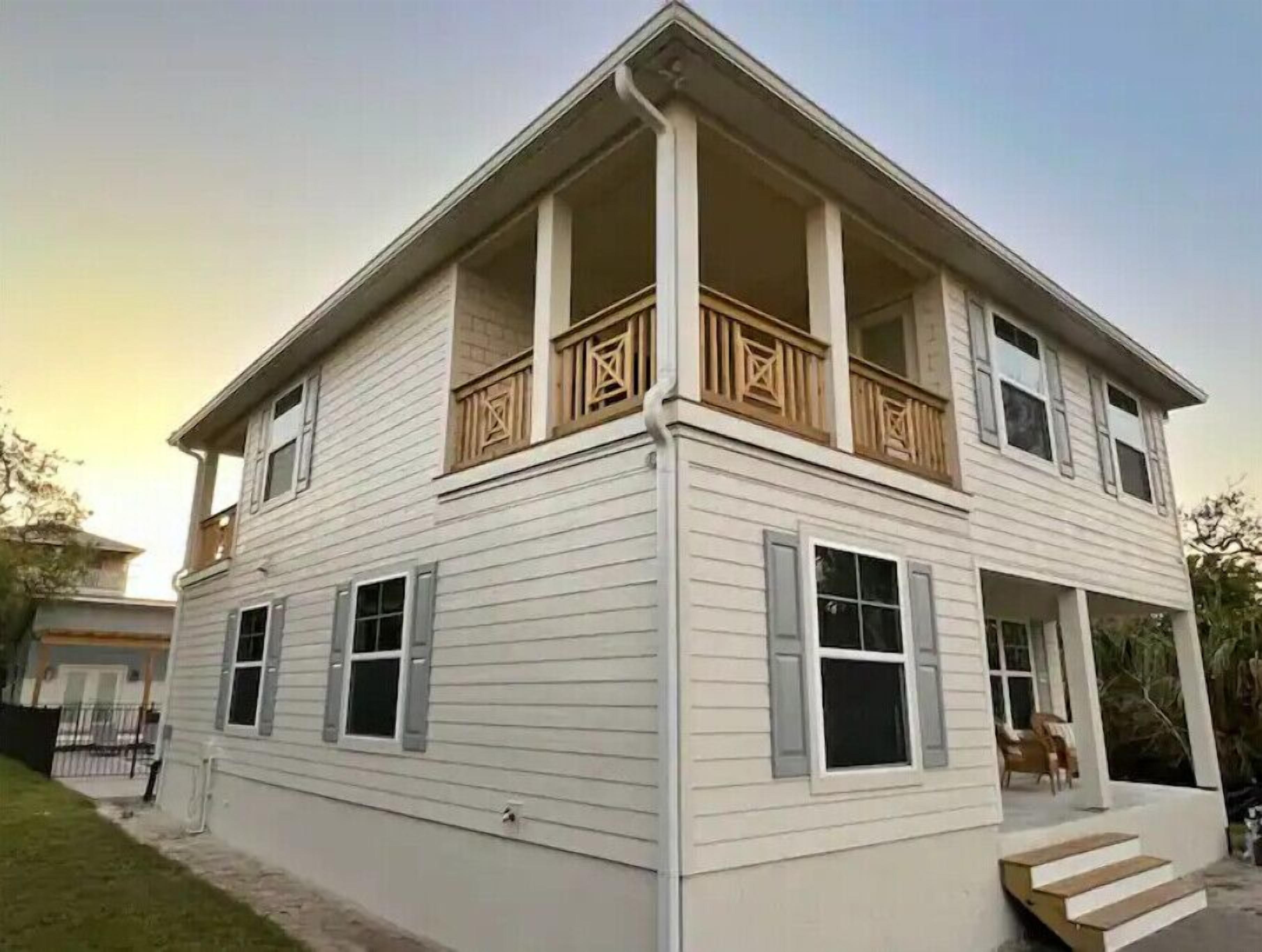 A two-story house with a balcony and a front porch.