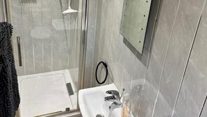 A modern bathroom with a glass-enclosed shower, a white sink with a soap dispenser, and a towel rack. - Lovely 1-bed Chalet in Mablethorpe (Mablethorpe)