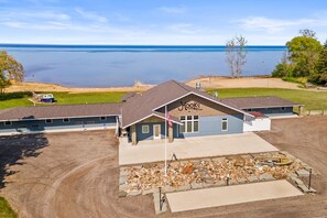 A building with a sign 'Hooks' on the front, a flagpole with an American flag, and a view of a lake.