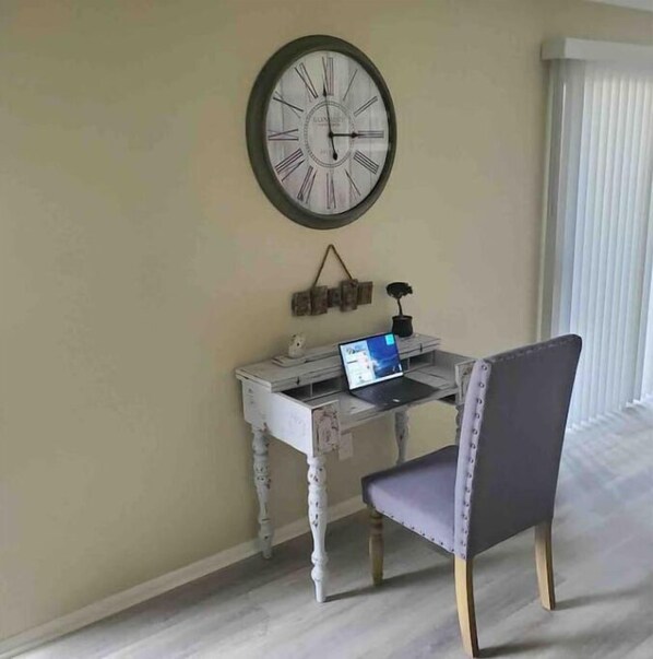 A room with a desk, chair, and a wall-mounted clock. - Destin, FL. Escape to Mirarmar Beach on Seascape resort (Miramar Beach)