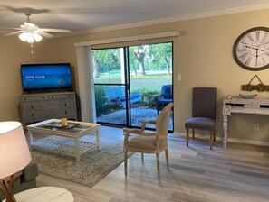 Relax in this stylish living room with a TV, outdoor access, and a cozy seating area.