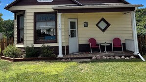 Une maison à deux étages avec un porche, une enseigne indiquant « Peterson Place », et une boîte aux lettres.