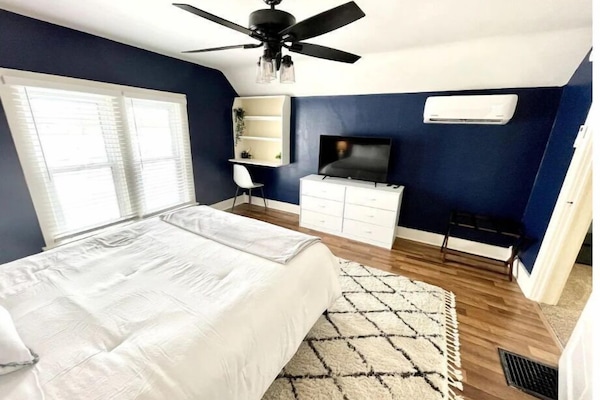 Large master bedroom with smart TV and desk area!