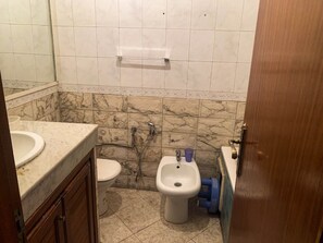 Bathroom features a sink, toilet, and bidet.