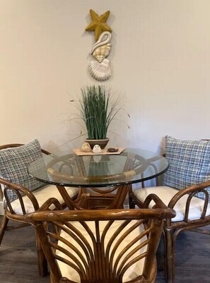 Enjoy meals around a round dining table with four comfortable chairs.