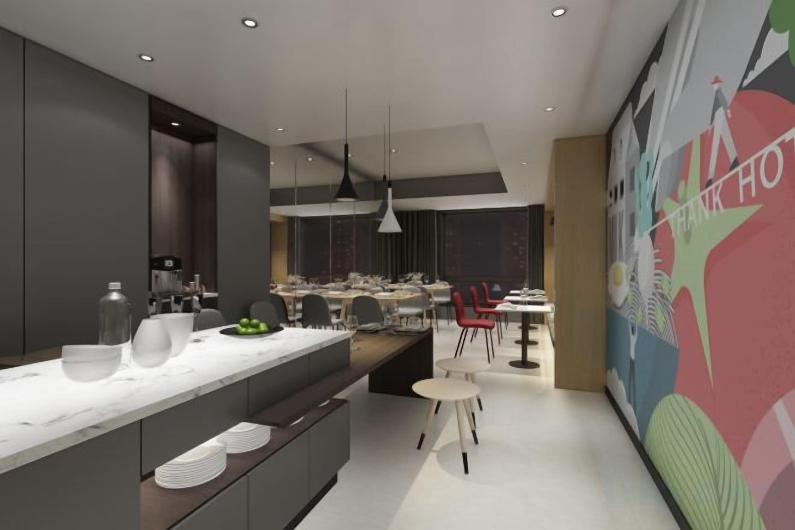 A modern kitchen with a large island, dining area with chairs, and a colorful mural on the wall.