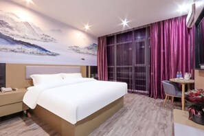 A hotel room with a large bed, a desk with a chair, a small table with a vase of flowers, and a large window with purple curtains. - Shankee Hotel (Wujiang Pedestrian Street) (Suzhou)