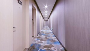 A hotel hallway with a patterned carpet, doors on the left, and a sign indicating room number 8301. - Shankee Hotel (Wujiang Pedestrian Street) (Suzhou)