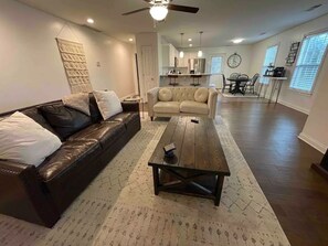 Relax in a spacious living area with a leather sofa, coffee table, and dining area.