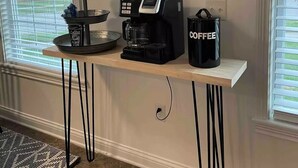 A kitchen area with a coffee maker, a mug rack, and a coffee bag on a wooden countertop. - Cheerful Three-Bedroom Residential Home (Richmond)