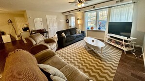 A living room with a sofa, coffee table, and TV.