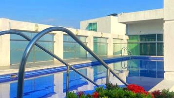 Outdoor pool, open 7:00 AM to 7:00 PM, pool umbrellas