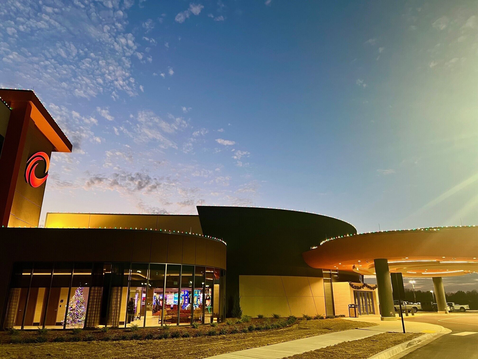 A modern building with a curved roof and a large entrance area.