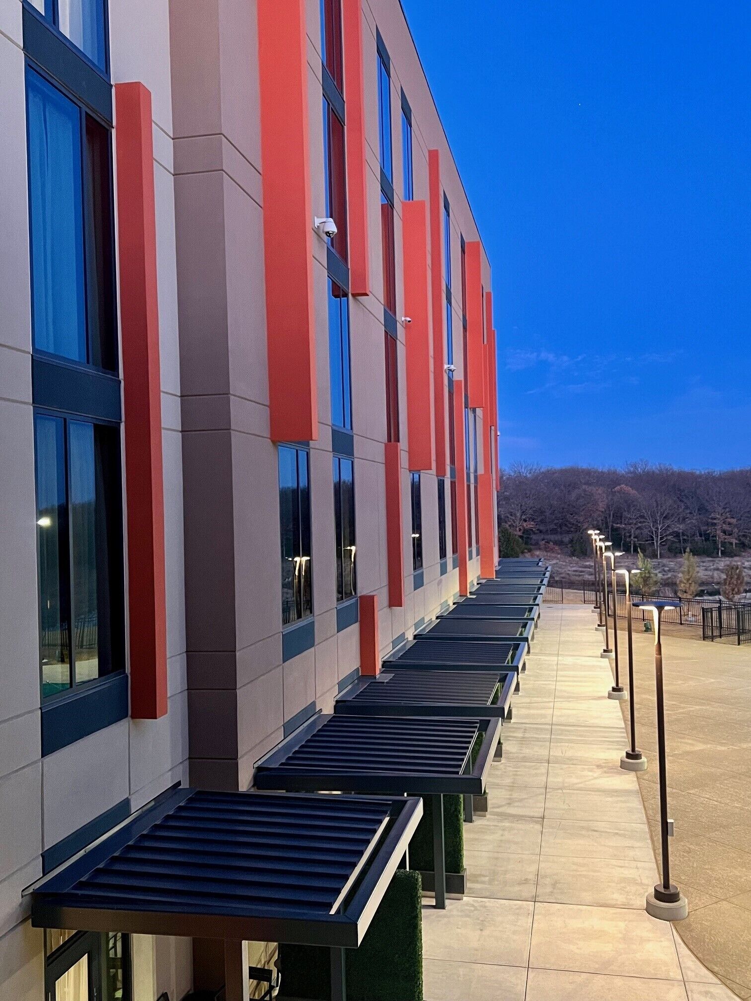 A modern building with a row of benches along the side.