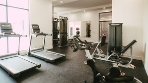 A gym with treadmills, a stationary bike, and weight machines. - Chic Cozy Retreat - 2BR - Stunning North End Views (Halifax)
