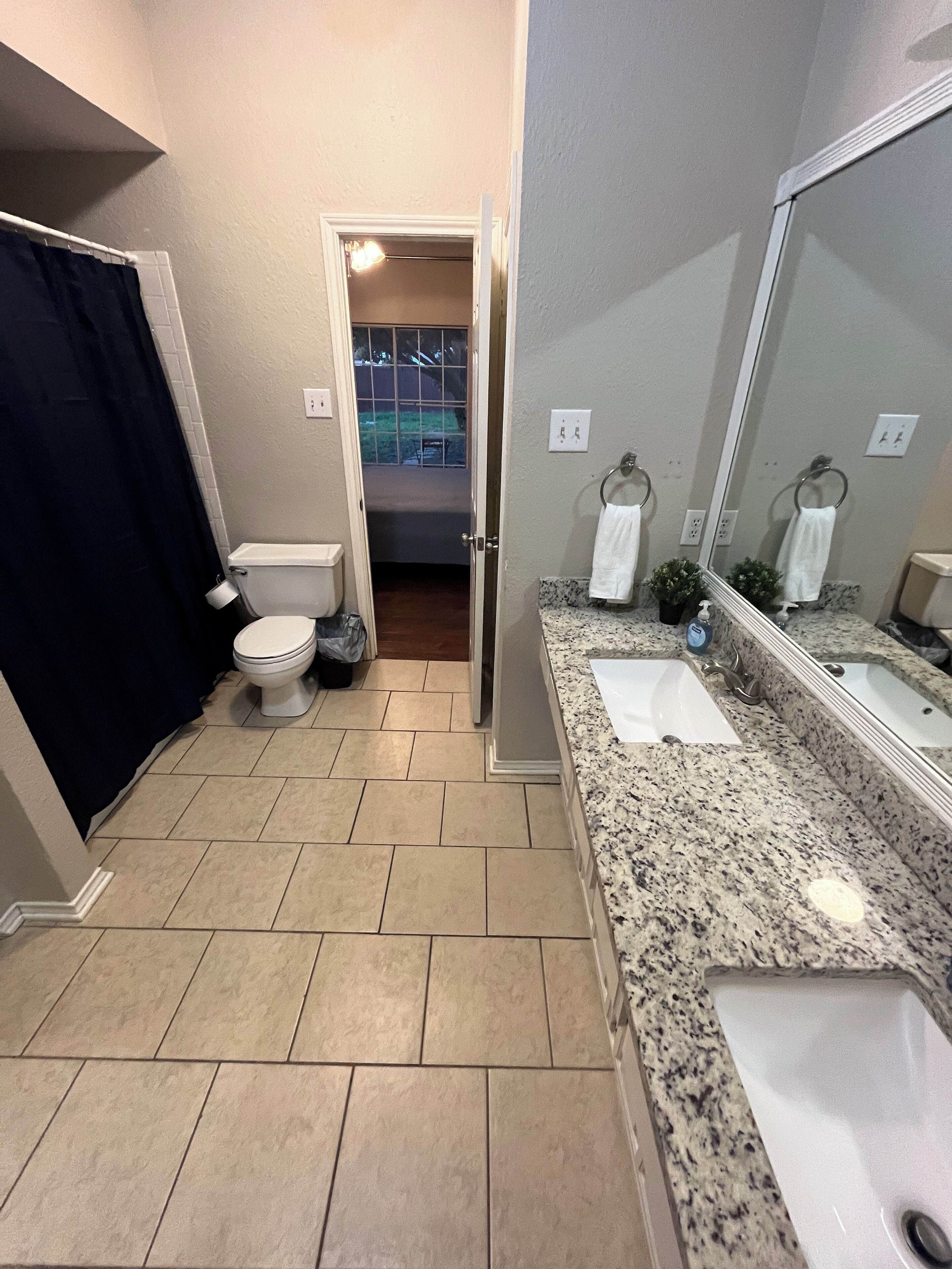 A bathroom with a toilet, sink, and bathtub.