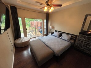A bedroom with a bed, a ceiling fan, a window, and a view of the outdoors. - Delightful Downtown Frisco House-Half a mile from Frisco downtown (Frisco)