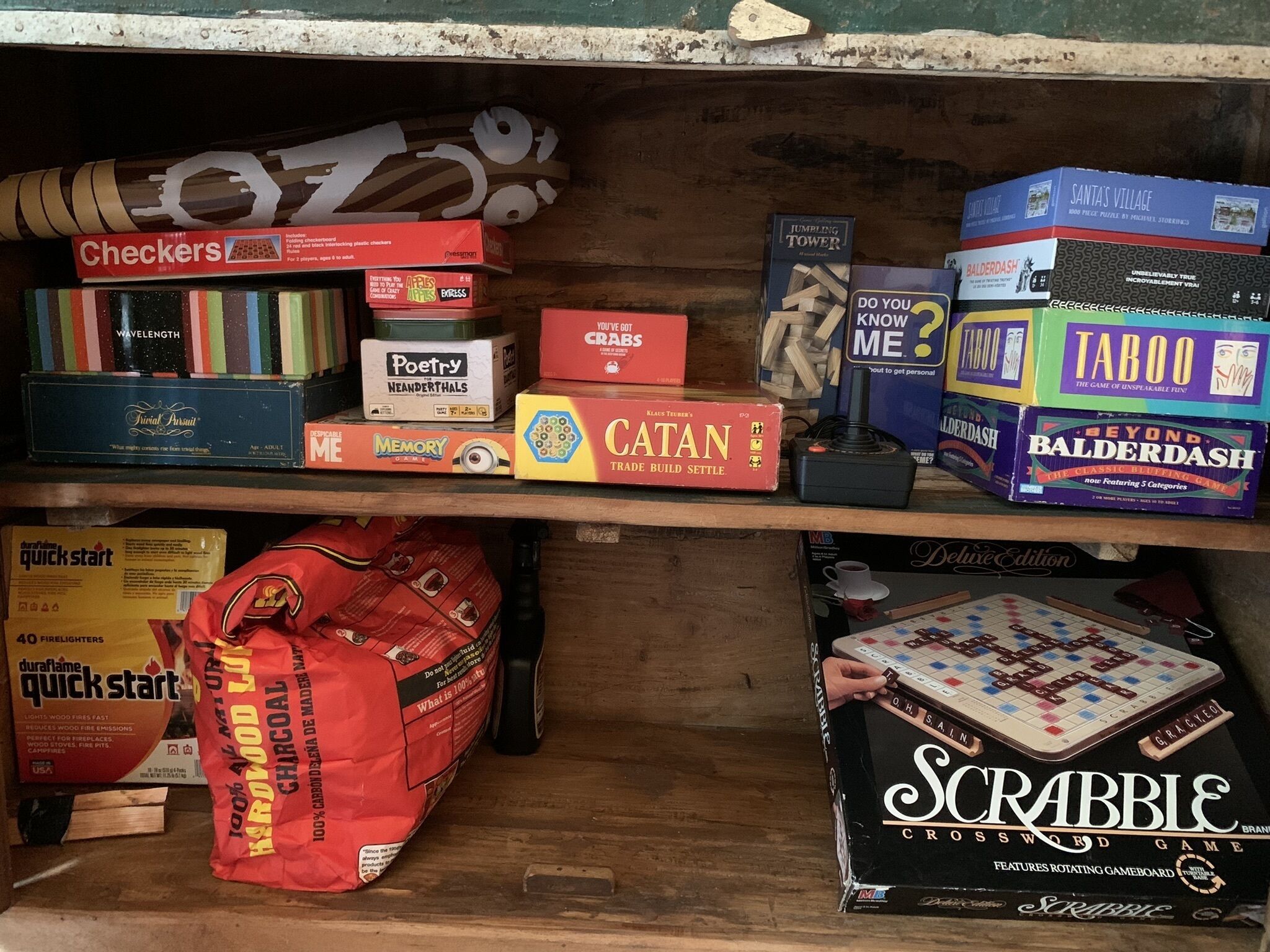 A shelf with various board games and a Scrabble box.
