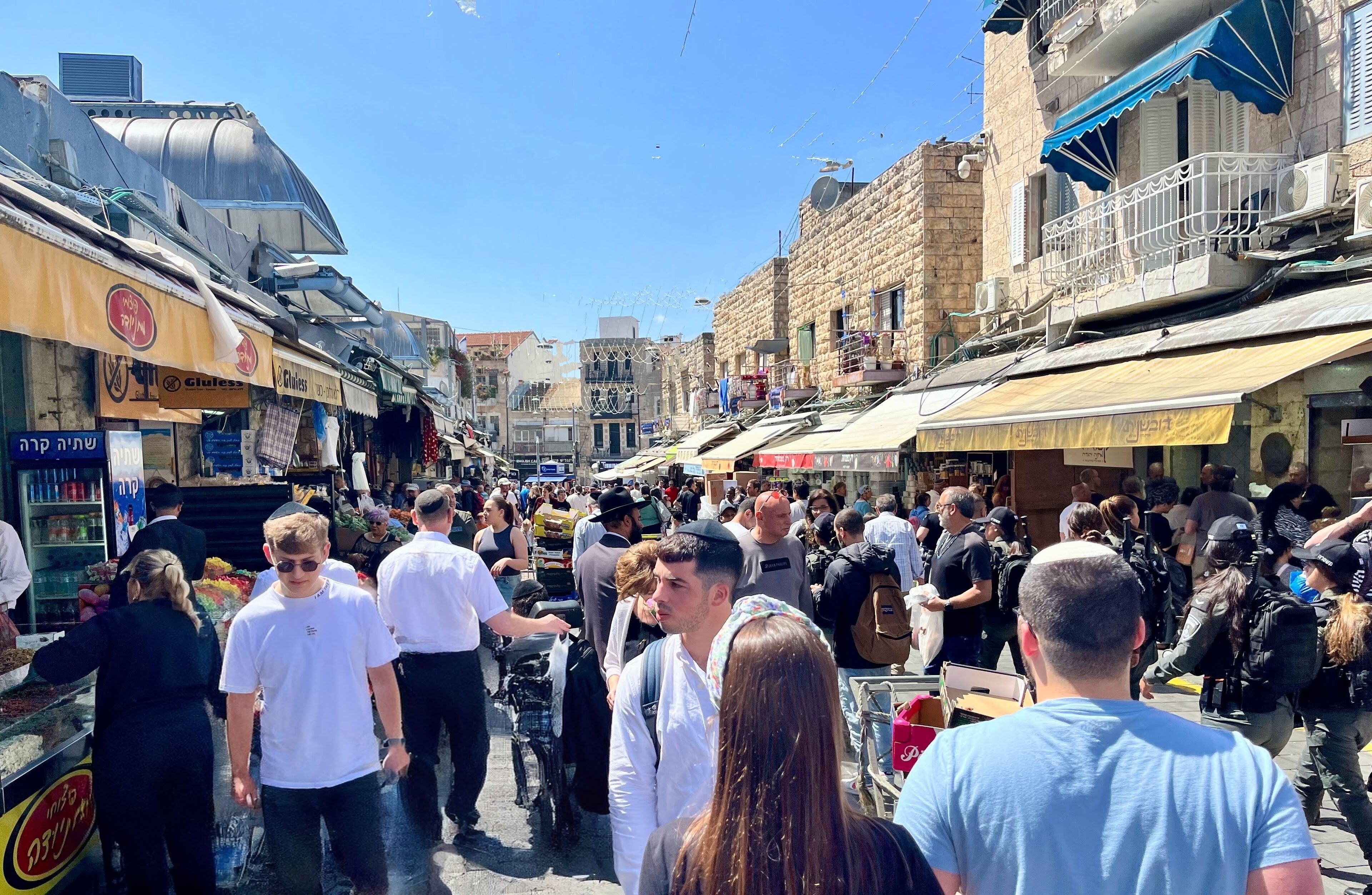 A crowded street with shops and buildings.