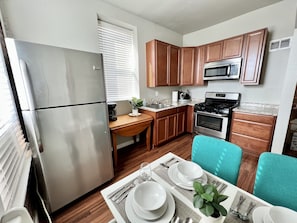 Fully stocked kitchen with stainless steel appliances and coffee maker