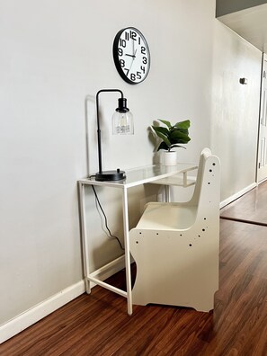 Dedicated workspace with desk, chair, and lamp