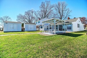 A two-story house with a covered patio and a detached garage. - Refreshing Colonial Beach Vacation Rental! (Colonial Beach)