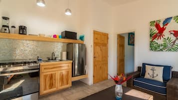 A modern kitchen with a stainless steel refrigerator, wooden cabinets, and a tiled backsplash.