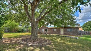 A single-story house with a front yard, a tree, and a wooden fence. - Comanche, Cameron,  Good Year, Fort-Sill, Medicine Park, Lawton, Oklahoma. 
 (Lawton)