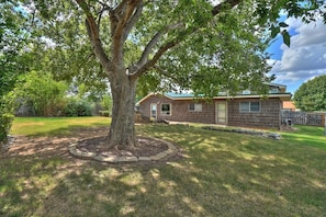 A single-story house with a front yard, a tree, and a wooden fence. - Comanche, Cameron,  Good Year, Fort-Sill, Medicine Park, Lawton, Oklahoma. 
 (Lawton)