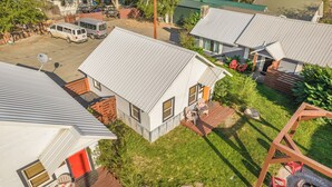 A residential area with multiple houses, each featuring a sloped metal roof and a small front porch. - Salmon River Cabin #204 (Riggins)