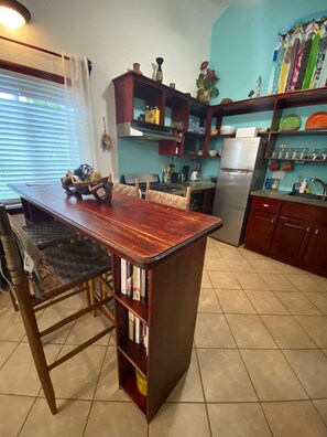 Enjoy cooking and dining in this well-equipped kitchen with a central island, gas stove, and stainless steel refrigerator.