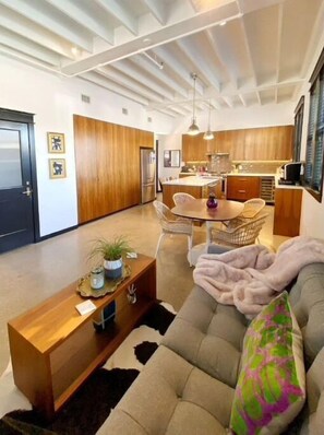 Enjoy meals in the central dining area with a wooden table and comfortable seating.
