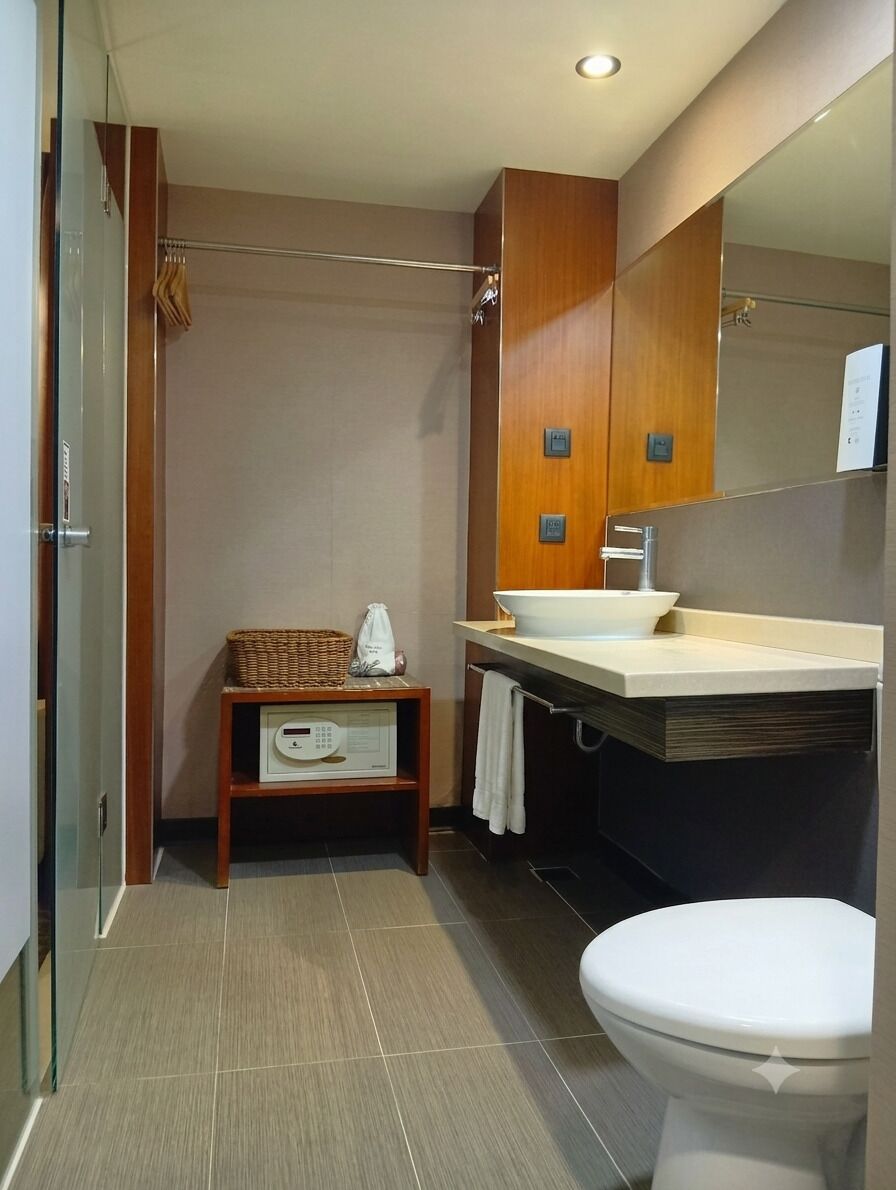 A modern bathroom with a toilet, sink, and shower area.