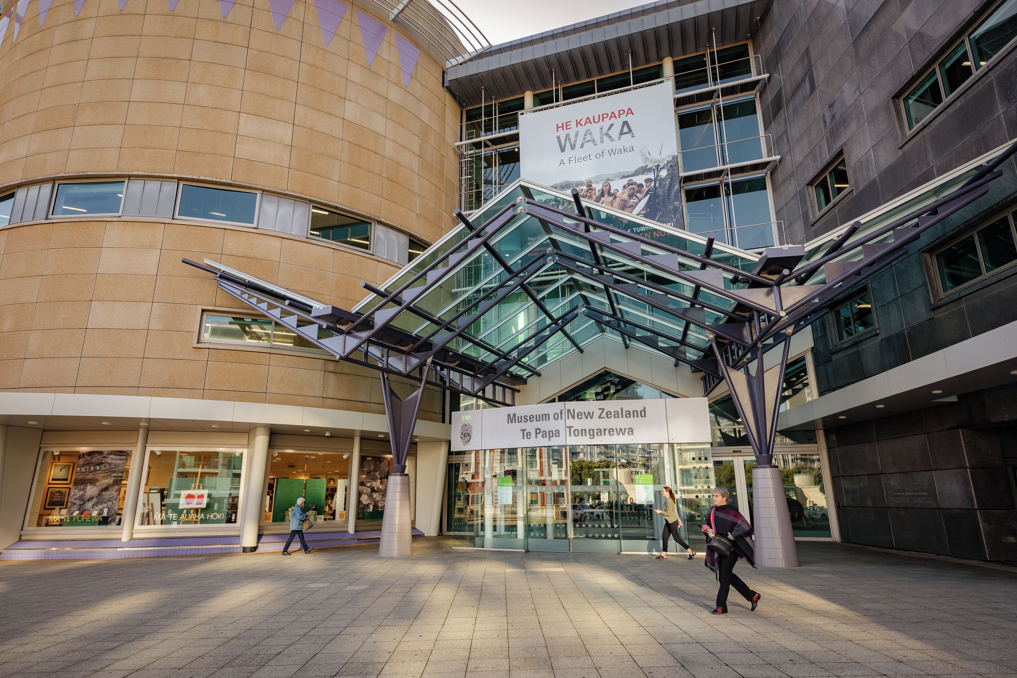 The entrance to the Museum of New Zealand Te Papa Tongarewa with a prominent sign and modern architecture.