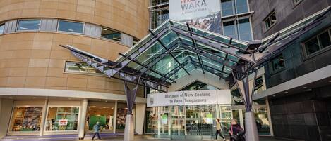 The entrance to the Museum of New Zealand Te Papa Tongarewa with a prominent sign and modern architecture.