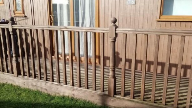 A wooden house with a fenced porch, a window, and a door. - Chalet Retreat in Mablethorpe (Mablethorpe)