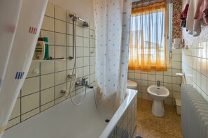 Baignoire, articles de toilette gratuits, sèche-cheveux