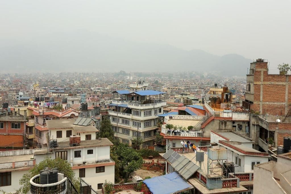 A densely packed urban area with multi-story buildings, some with visible water tanks on rooftops.