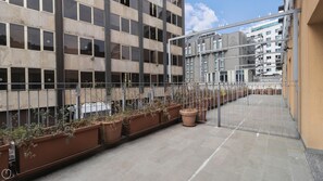 A multi-story building with a modern design, featuring large windows and a metal gate. - Italianway Collection - Corso Como 11 - F (Milan)
