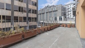 A rooftop terrace with terracotta planters and a view of adjacent buildings. - Italianway - Corso Como 11 - 8 (Milan)