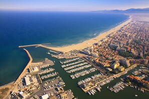 An aerial view of a coastal city with a marina, beach, and dense urban area. - STUDIO 23 M2 AT THE PORT AND BEACH (Canet en roussillon)
