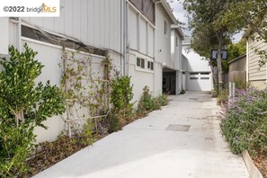 Stroll down this charming residential street lined with mature trees and shrubs.