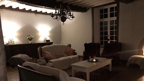 A cozy living room with a sofa, armchairs, and a coffee table.