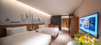 A hotel room with two beds, a wall-mounted TV, and a decorative wall mural.