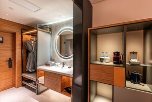 A modern bathroom with a vanity, mirror, and storage cabinets.