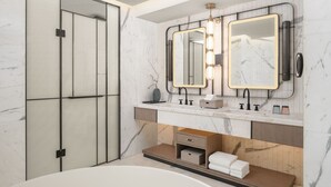 A modern bathroom with a large mirror, two sinks, and a bathtub. - Sheraton Beihai Resort (Beihai)