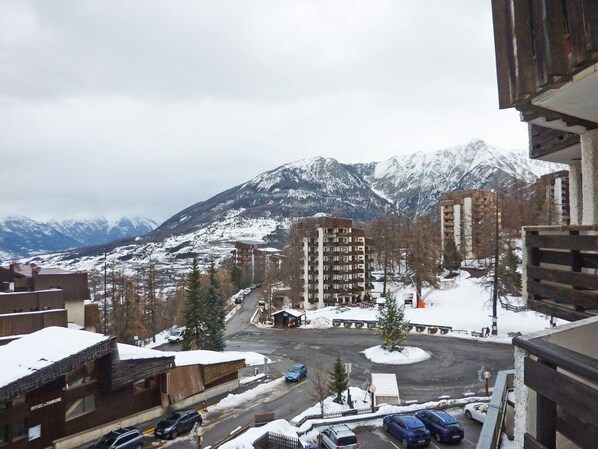 A view of a town with buildings and a mountain in the background.